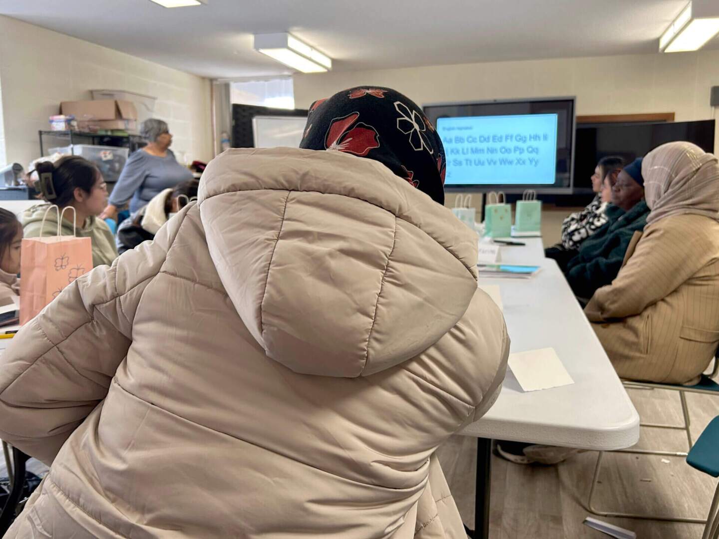 Women refugees gather to socialize and practice English during a weekly group class at the Refugee Dream Center in Providence. Many rely on federal food assistance and government health insurance, but will lose access under federal budget cuts in 2026.