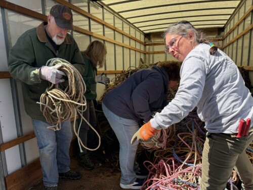 Eva Murray directs volunteers unloading the rope from the truck.