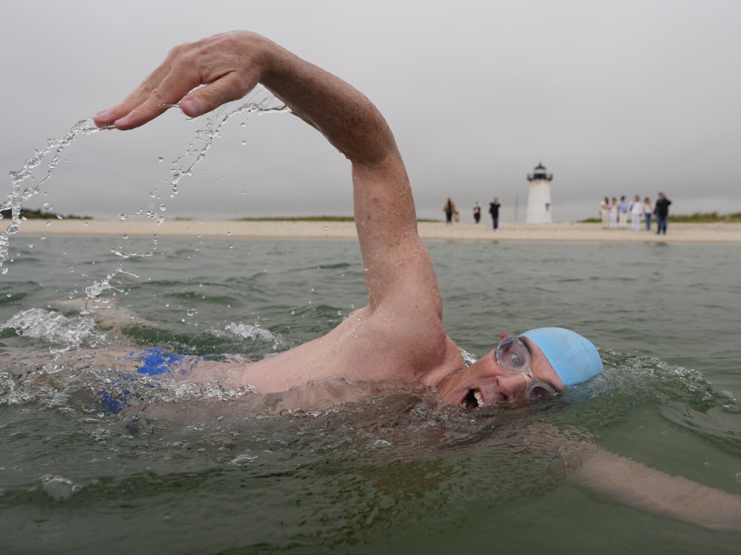 Endurance swimmer Lewis Pugh swims near the Edgartown Harbor Light, Thursday, May 15, 2025, in Edgartown, Mass.