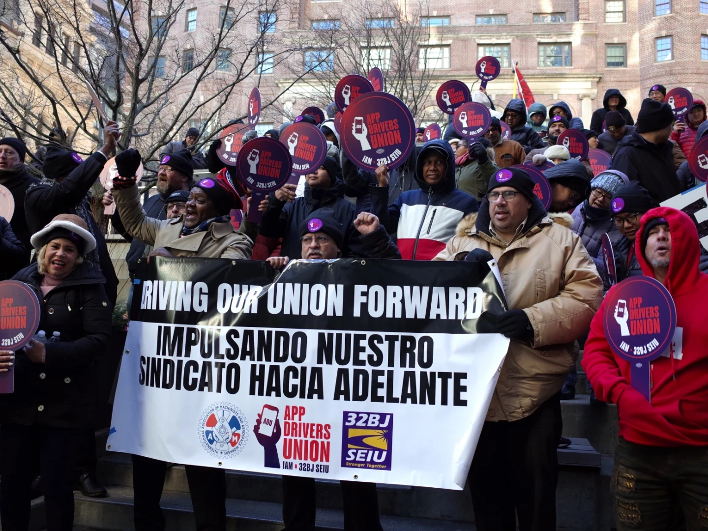 Uber and Lyft drivers rally outside the Massachusetts Department of Transportation Building in Downtown Boston, Wednesday, Dec. 4, 2024