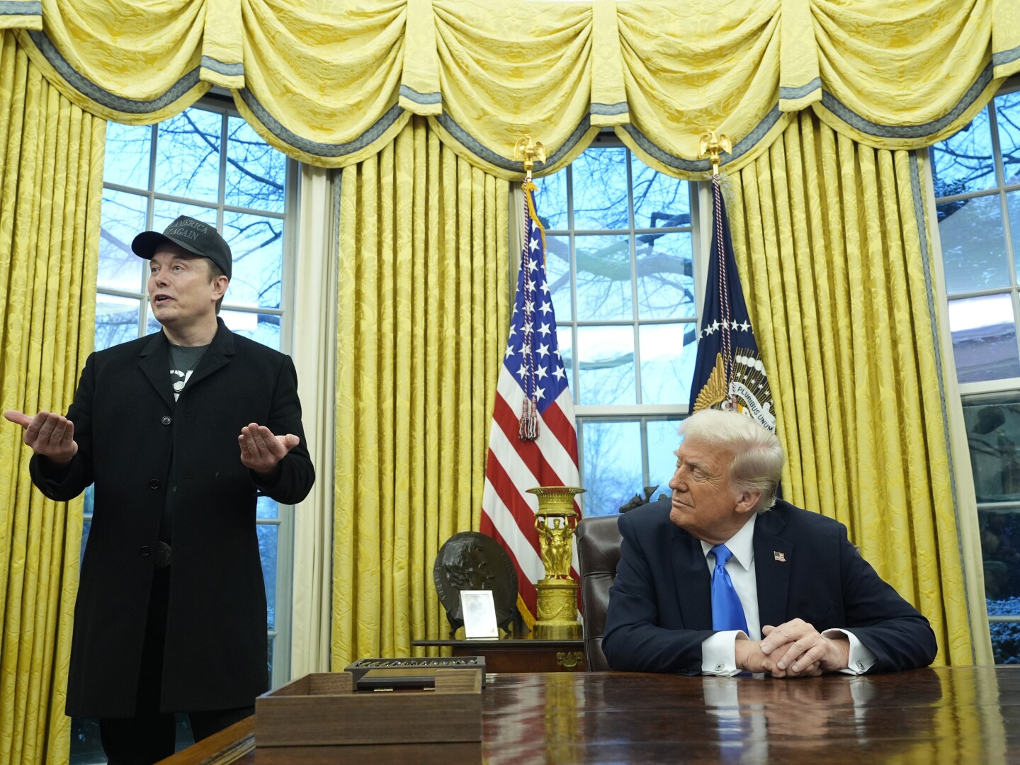President Donald Trump listens as Elon Musk speaks in the Oval Office at the White House, Tuesday, Feb. 11, 2025, in Washington. (AP Photo/Alex Brandon)