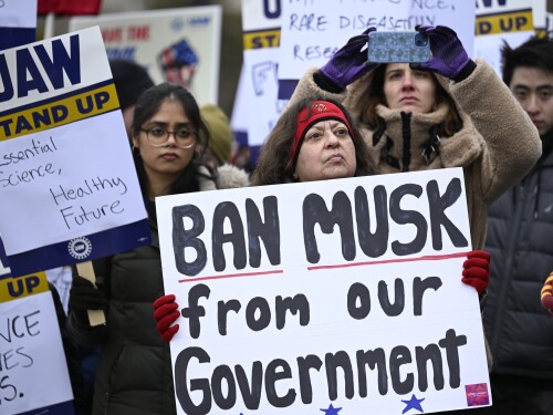 People rally at Health and Human Services headquarters to protest the polices of President Donald Trump and Elon Musk Wednesday, Feb. 19, 2025, in Washington.