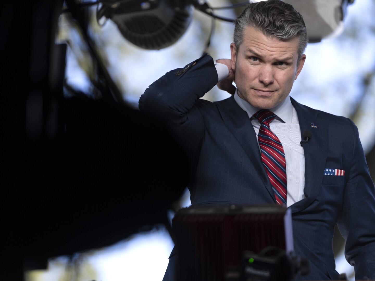 Defense Secretary Pete Hegseth prepares to give a television interview outside the White House, Friday, March 21, 2025, in Washington.