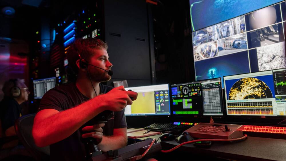 URI Ph.D. student Jake Bonney working in the Ocean Exploration Trust control van.