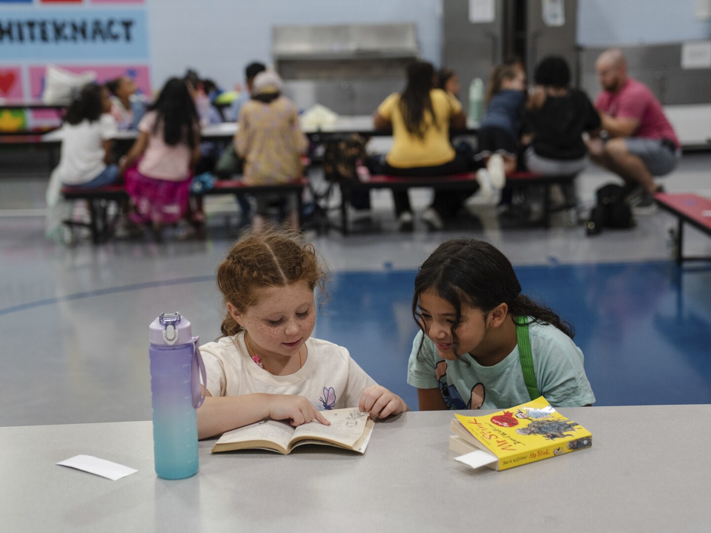 Girls read an Amelia Bedelia book during the East Providence Boys and Girls Club Summer Camp at Emma G. Whiteknact Elementary School on Thursday, July 10, 2025, in Providence R.I.