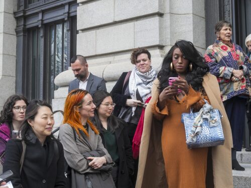 Plaintiffs in Rhode Island Latino Arts vs. National Endowment for the Arts, attorneys from the from the American Civil Liberties Union and supporters are seen outside the U.S. District Court for the District of Rhode Island in Providence on March 27, 2025. The ALCU is representing the performing arts group plaintiffs in hopes of defeating a National Endowment for the Arts funding policy that could affect funding for LGBTQ+ artists and performers.