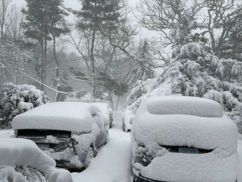 Snow blankets vehicles in Smithfield, RI on Monday morning during blizzard.