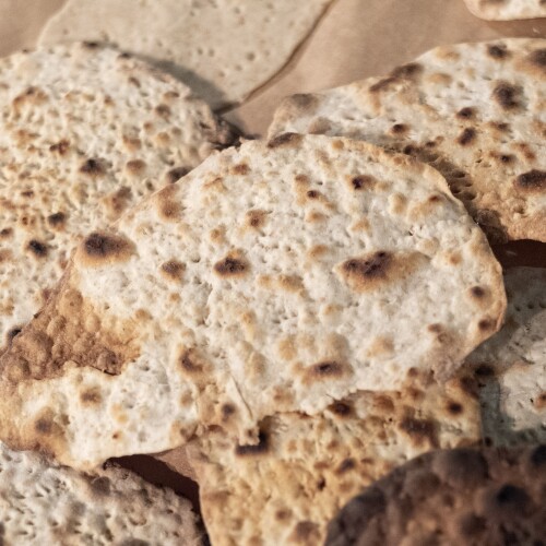 FILE - Freshly baked handmade matzo is seen after being prepared by first graders from Milton Gottesman Jewish Day School of the Nation's Capital at the JCrafts Center for Jewish Life and Tradition in Rockville, Md., April 18, 2024.
