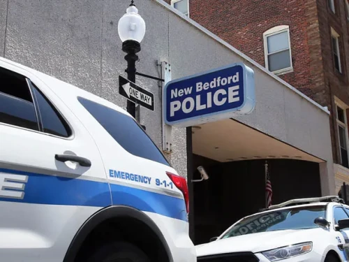 Police cruisers outside a police station in New Bedford.