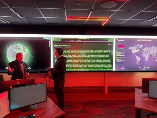 Rhode Island College Computer Science professor Tim Henry speaks with Ocean State Media’s James Baumgartner at the ‘cyber range’ at the Institute for Cybersecurity & Emerging Technologies.