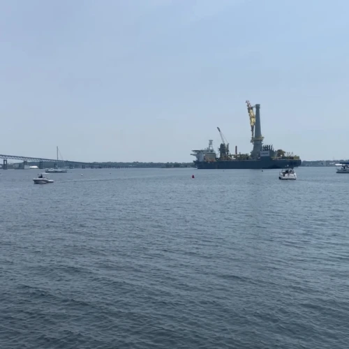 A crane ship in Narragansett Bay, supporting construction of offshore wind turbines, is part of what had been a growing sector of Rhode Island’s economy now under threat.