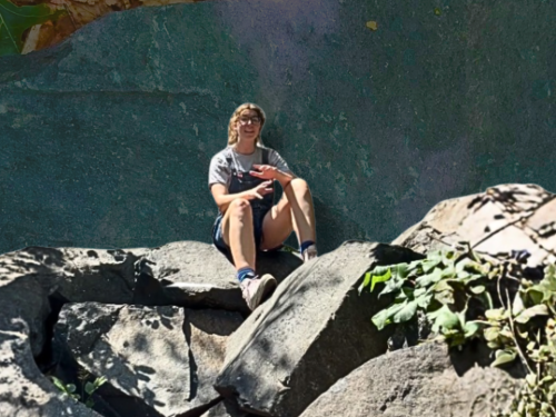 Allison Magnus atop Cumberlandite boulder.