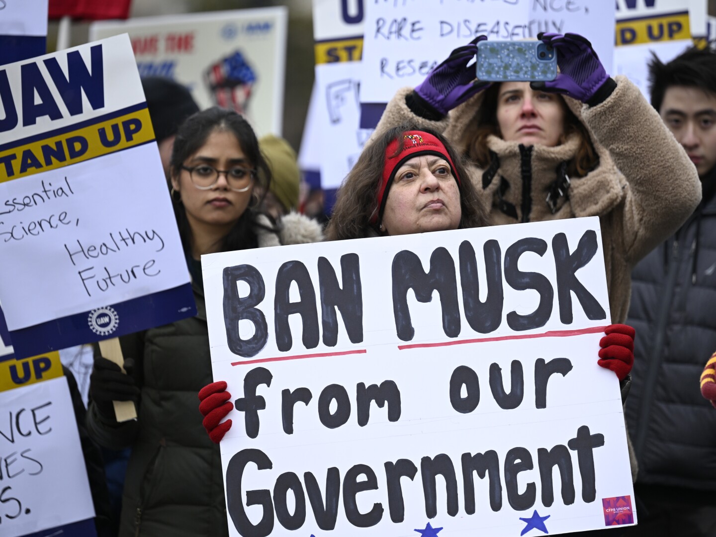 People rally at Health and Human Services headquarters to protest the polices of President Donald Trump and Elon Musk Wednesday, Feb. 19, 2025, in Washington.