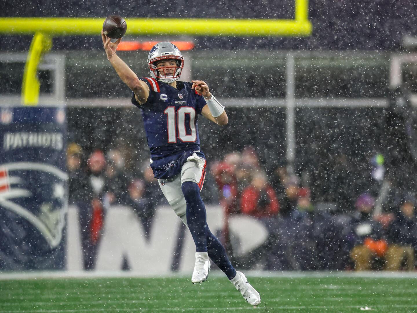 New England Patriots quarterback Drake Maye (10) rolls out of the pocket to make a pass during the second half of an NFL divisional playoff football game against the Houston Texans, Sunday, Jan. 18, 2026, in Foxborough, Mass.