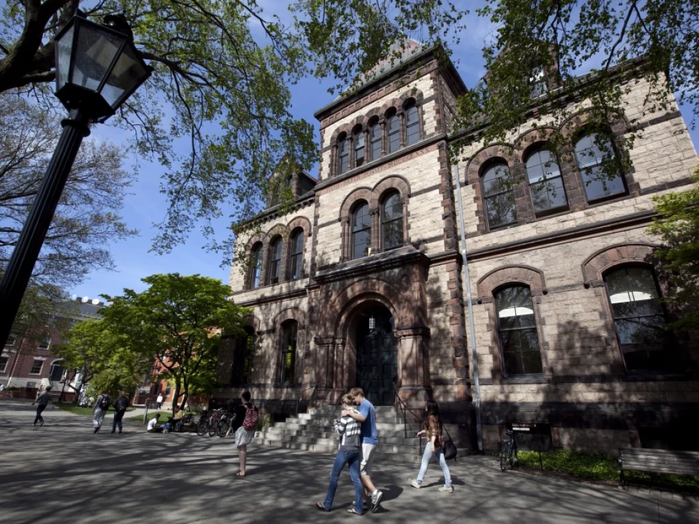 FILE - Passersby walk past Sayles Hall on Brown University’s campus in Providence, R.I., May 7, 2012.
