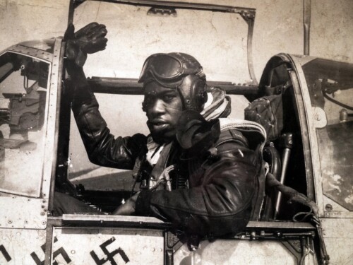A photograph of Tuskegee Airman Lt. Col. Bertram W. Wilson in the cockpit of his plane can be seen in the New England Air Museum exhibit.