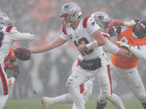 New England Patriots quarterback Drake Maye (10) hands off against the Denver Broncos during the second half of the AFC Championship NFL football game, Sunday, Jan. 25, 2026, in Denver.