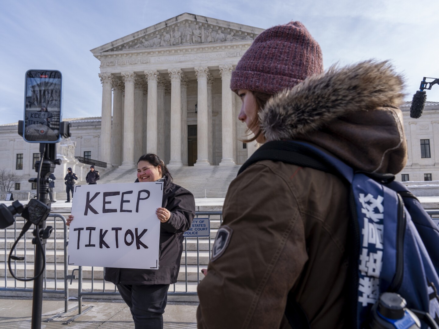 Callie Goodwin, of Columbia, S.C., holds a sign in support of TikTok outside the Supreme Court, Friday, Jan. 10, 2025, in Washington. Goodwin, a small business owner who sells personalized greeting cards, says 80% of her sales come from people who found her on TikTok.
