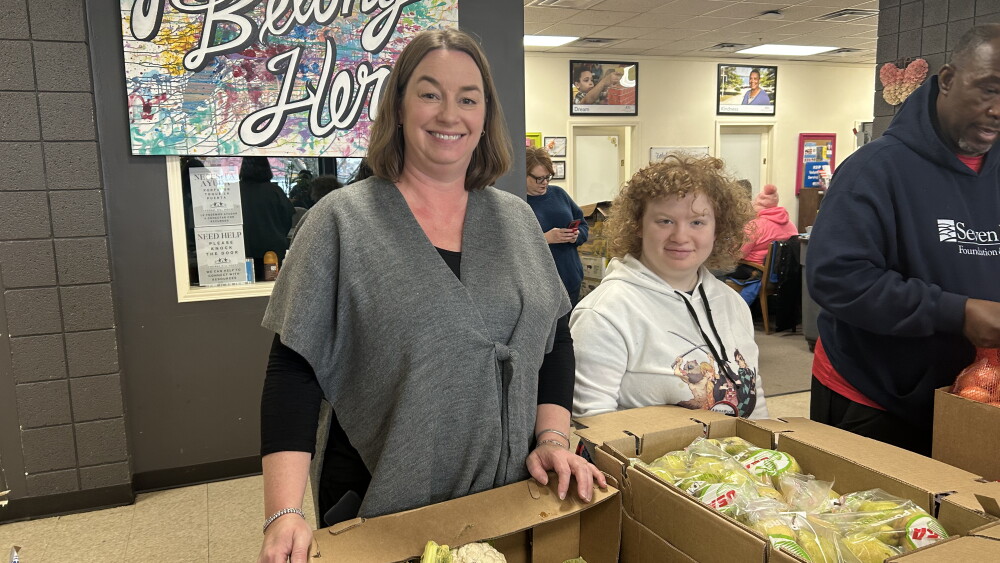 Kimberly Fernandez and a volunteer at Federal Hill House’s food pantry in Providence, Rhode Island.
