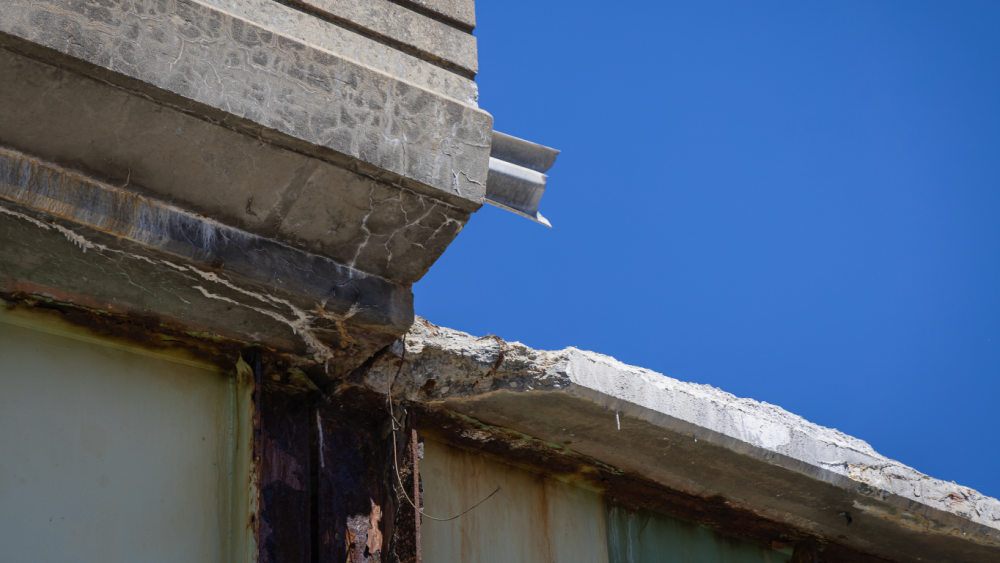 A chunk of the ramp’s outer wall – the parapet and a facade that acts as a buffer to keep electricity from jumping off rail tracks – fell onto Amtrak tracks.