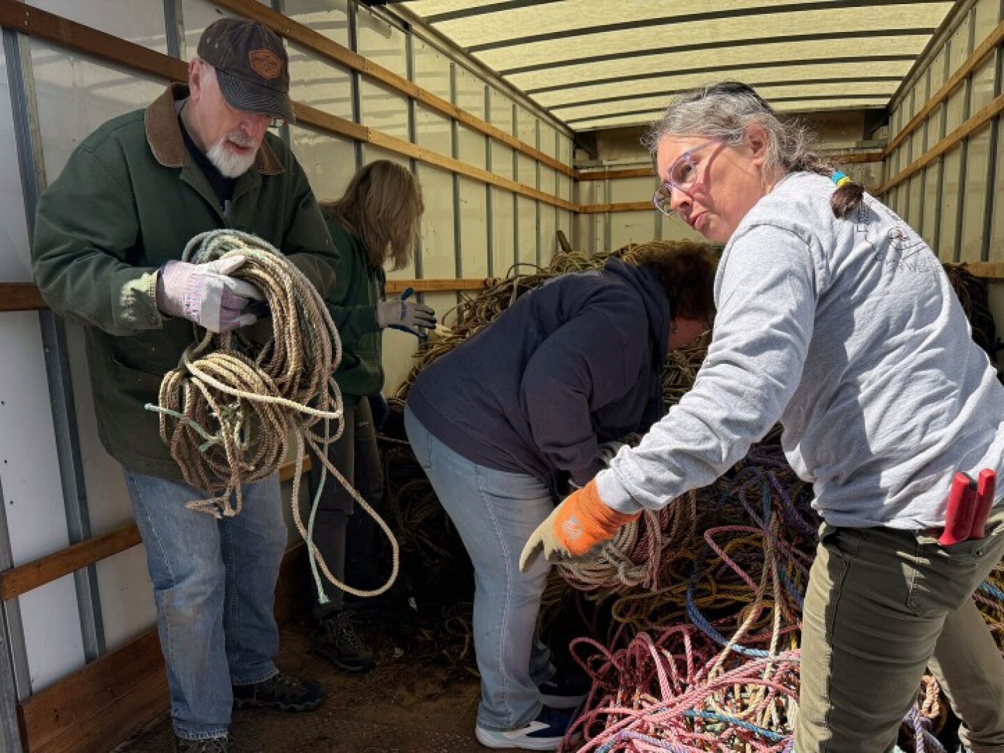 Eva Murray directs volunteers unloading the rope from the truck.