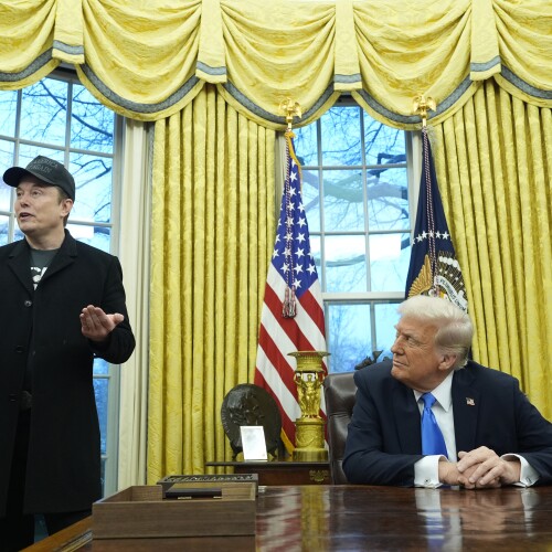 President Donald Trump listens as Elon Musk speaks in the Oval Office at the White House, Tuesday, Feb. 11, 2025, in Washington. (AP Photo/Alex Brandon)