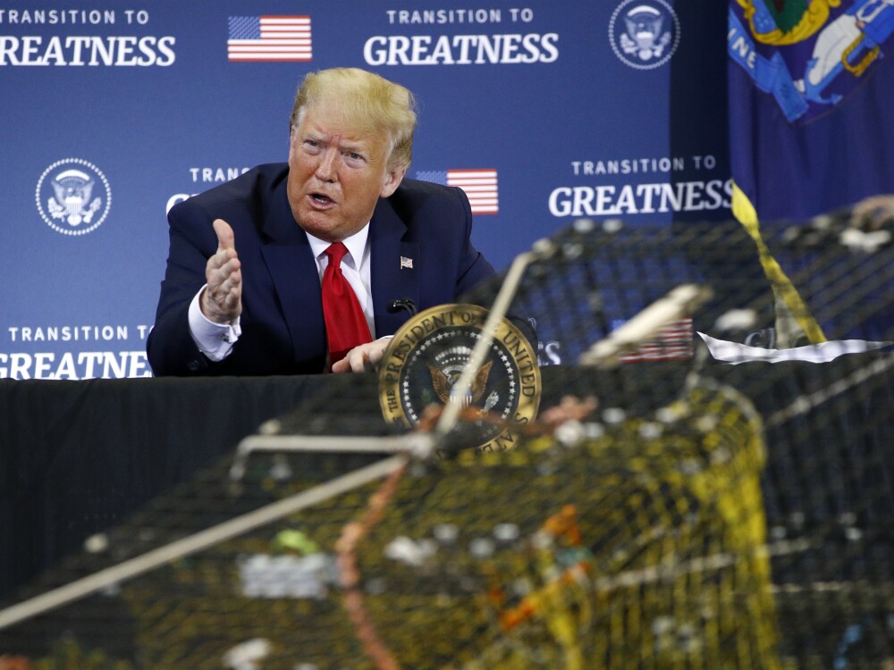 FILE - President Donald Trump attends a roundtable discussion with commercial fishermen at Bangor International Airport in Bangor, Maine, June 5, 2020. 