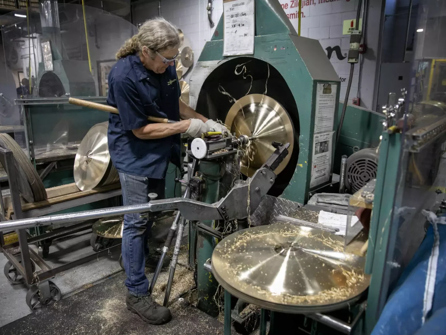Cymbalsmith Peter Nelson works on a cymbal on a lathe at the Zildjian cymbal factory in Norwell, Mass.