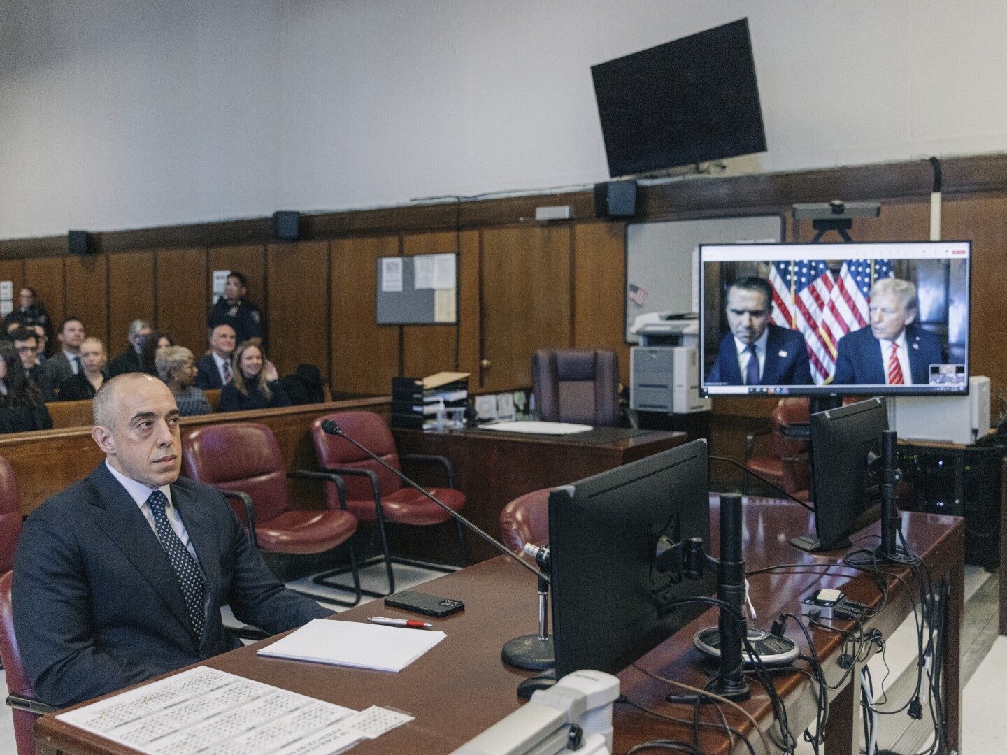 Emil Bove, attorney for former US President Donald Trump, left, sits in Manhattan criminal court as Todd Blanche, on screen left, attorney for Trump and Trump, appear remotely on a screen at Manhattan criminal court for Trump's sentencing in the hush money case in New York, Friday, Jan. 10, 2025.