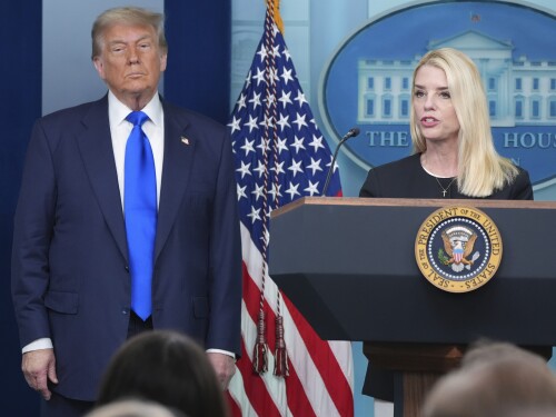 Attorney General Pam Bondi speaks to reporters as President Donald Trump listens, Friday, June 27, 2025, in the briefing room of the White House in Washington.