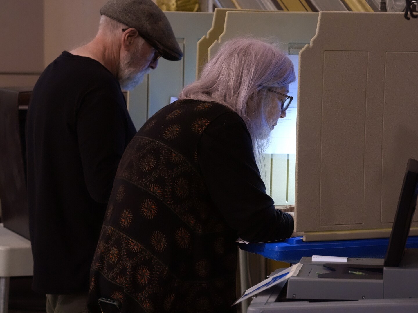 Voters mark their ballots during early voting in the general election, Friday, Nov. 1, 2024, at City Hall in Providence, R.I. (AP Photo/Steven Senne)