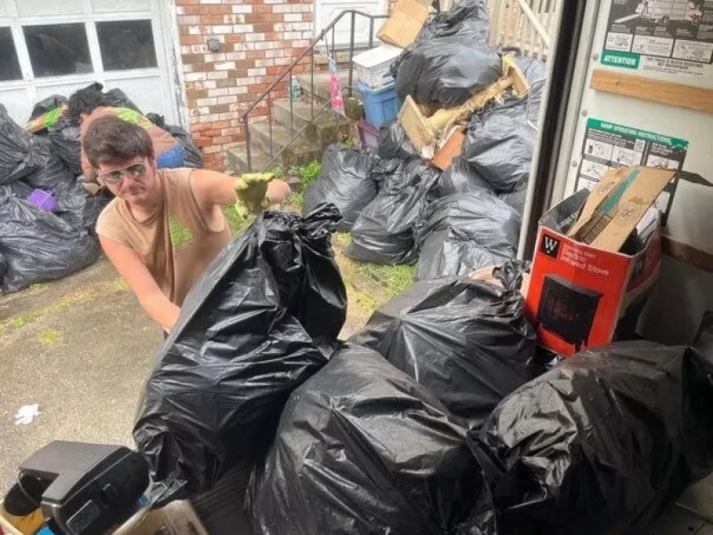 Tristen Williams helps remove clutter from the home of someone with hoarding disorder in Greensburg, Pennsylvania. The homeowner decided to ask for help with the cleanout after attending a course and support group offered by the nonprofit Fight the Blight, founded by Williams' father.