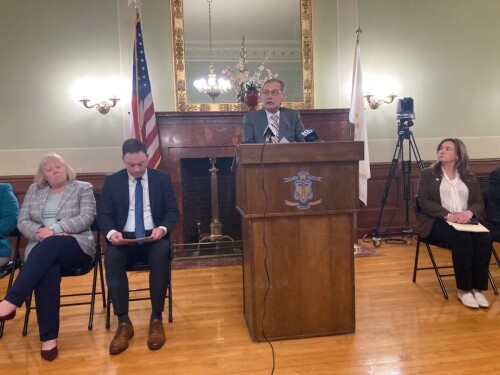 Senate President Dominick Ruggerio, at the podium during a March 2024 news conference, wants to elevate Democratic Whip Val Lawson, far left, over Ryan Pearson, left.