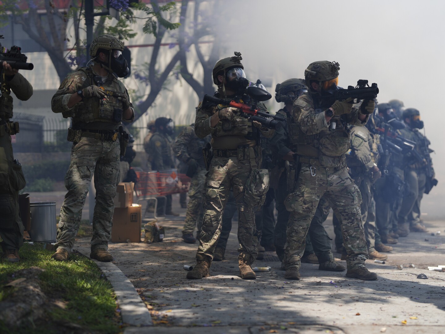 Law enforcement stand during a protest in Paramount, Calif., Saturday, June 7, 2025, after federal immigration authorities conducted operations.