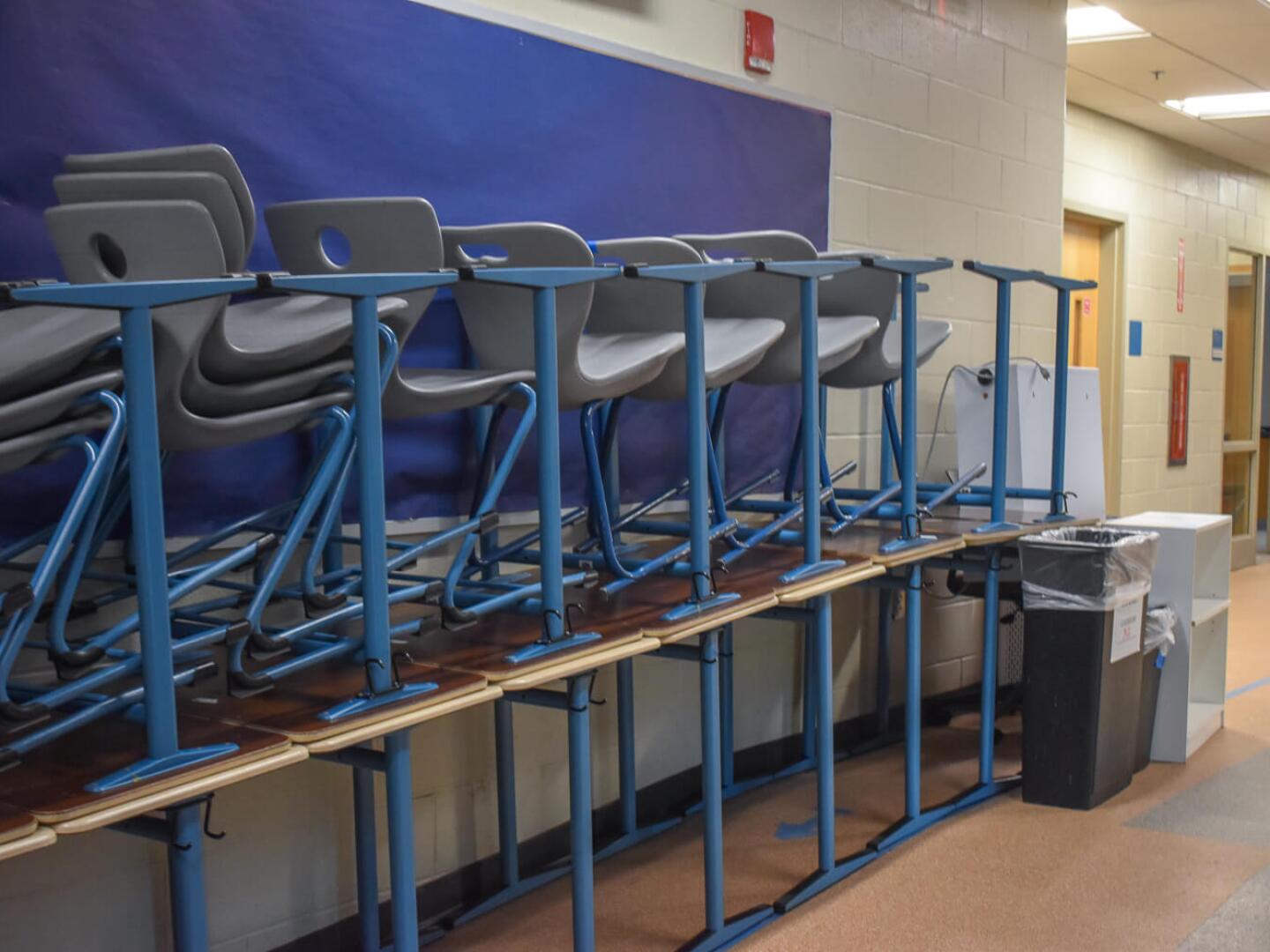 Chairs seen stacked on top of desks in a hallway at the Providence Career & Technical Academy.
