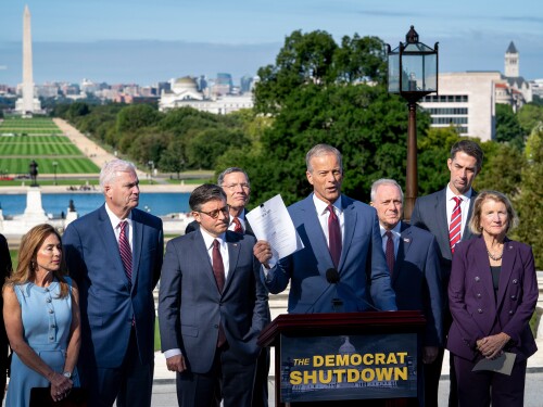 Speaker of the House Mike Johnson, R-La., left, listens as Senate Majority Leader John Thune, R-S.D., holds a copy of the continuing appropriations bill as top Republicans in Congress hold a news conference on the government shutdown, at the Capitol in Washington, Wednesday, Oct. 1, 2025.