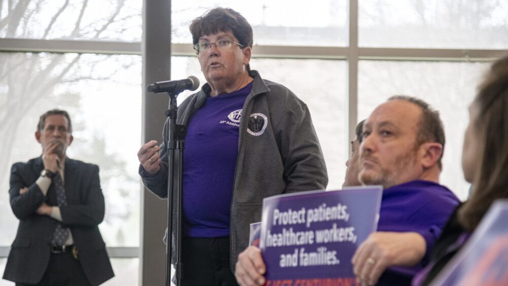 Lynn Blais, United Nurses & Allied Professionals Local 5110 president, is shown speaking. She has power of attorney for her aunt, who is in a nursing home and is one of 275 people who will lose subsidized Medicare Advantage coverage through Blue Cross & Blue Shield of Rhode Island.