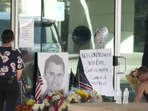 Well-wishers pay their respects at a makeshift memorial at the national headquarters of Turning Point USA shown after the shooting death of Charlie Kirk, the co-founder and CEO of the organization, during a Utah college event Wednesday, Sept. 10, 2025, in Phoenix.