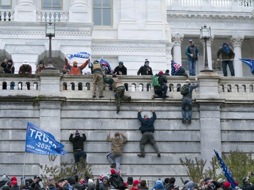 FILE - Supporters of President Donald Trump climb the west wall of the the U.S. Capitol in Washington, Jan. 6, 2021.