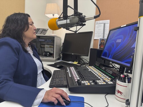 Jaclyn Sallee, president and chief operating for Koahnic Broadcast Corp.,starts a computer July 10, 2025, at the Anchorage, Alaska, studios of KBNA, the flagship station for National Native News.