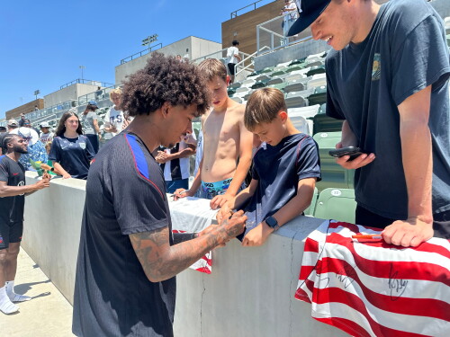 United States defender Chris Richards, front left, gives autographs to fans after the nationall team's first practice at its World Cup soccer tournament training base in Irvine, Calif., Monday, June 8, 2026.