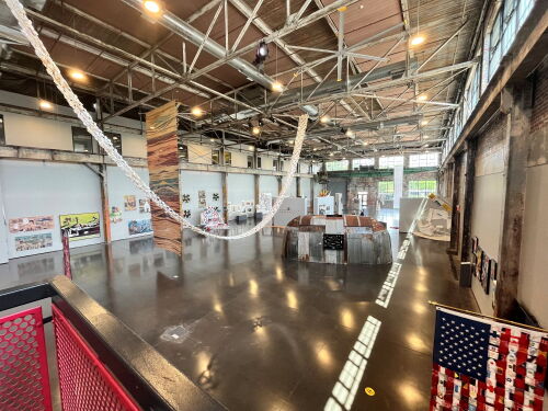 "America - Unfinished?!" features a steel longhouse from the Tomaquag Museum, a giant tapestry made from coconut leaves, a flag made from hospital gowns and more than 100 other works that examine the meaning of America 250