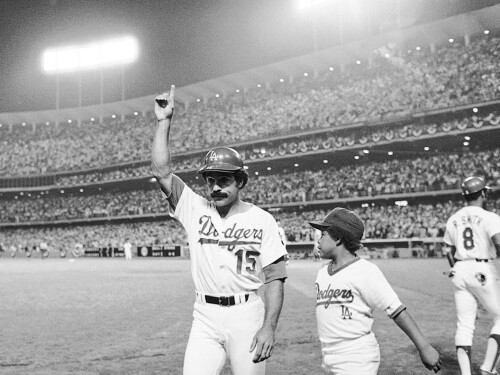 Los Angeles Dodgers Davey Lopes (15) signals to the crowd as he heads to the dugout on Tuesday, Oct. 10, 1978 in Los Angeles after hitting his second two-run home in the first game of the World Series. Youngster at right is Reggie Smith Jr.