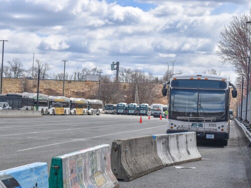 A fleet of Rhode Island Public Transit Authority buses is parked across the street from the agency’s Providence headquarters on Melrose Street.